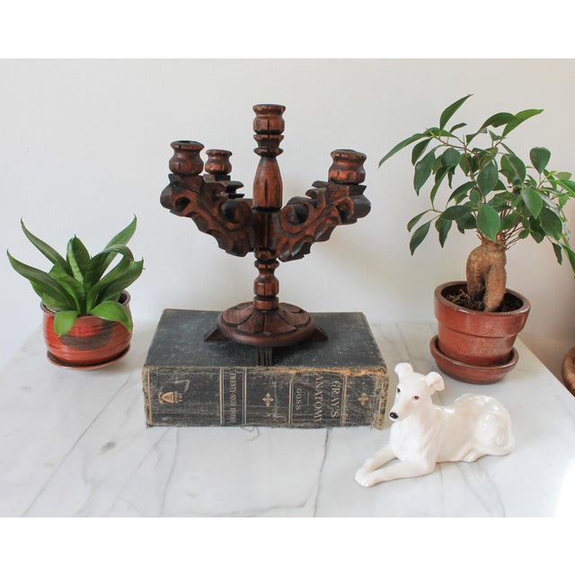 Vintage Spanish revival style carved wood five are candelabra. No makers mark. Some age wear. It is crooked.