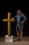 Undated and unmarked farmhouse-style painted cross. This rustic piece is mounted on a faux roof peak with corrugated tin...