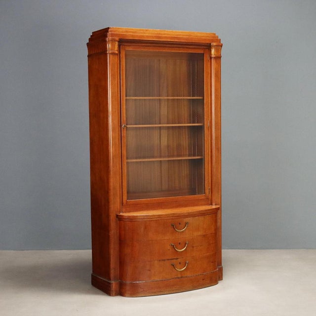 Art Nouveau mahogany display cabinet. Central glass door with three height-adjustable shelves. Half-moon base with three...