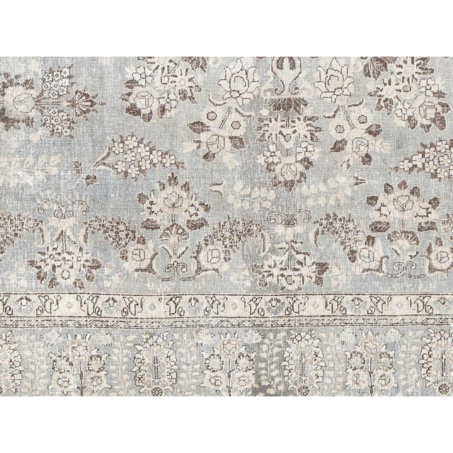 Expertly crafted, this Semi Antique Persian Tabriz Rug measures 9' x 12'6". With its delicate design and quality...