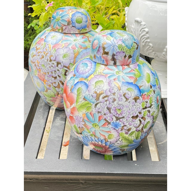 This pair of porcelain ginger jars features a richly hand-painted Famille Rose style floral design with vibrant peonies,...