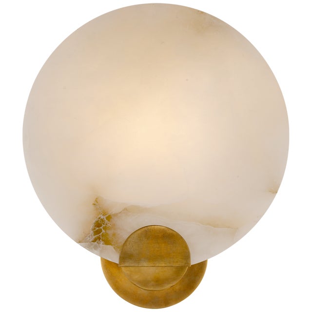 Iveala Single Sconce in Hand-Rubbed Antique Brass with Alabaster Shade Designer: AERIN Height: 12.75" Extension: 4.25"...