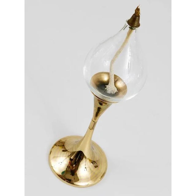 A beautiful modernist brass oil lamp candlestick, designed by Freddie Andersen, made in Western Germany in the 1970s. In...