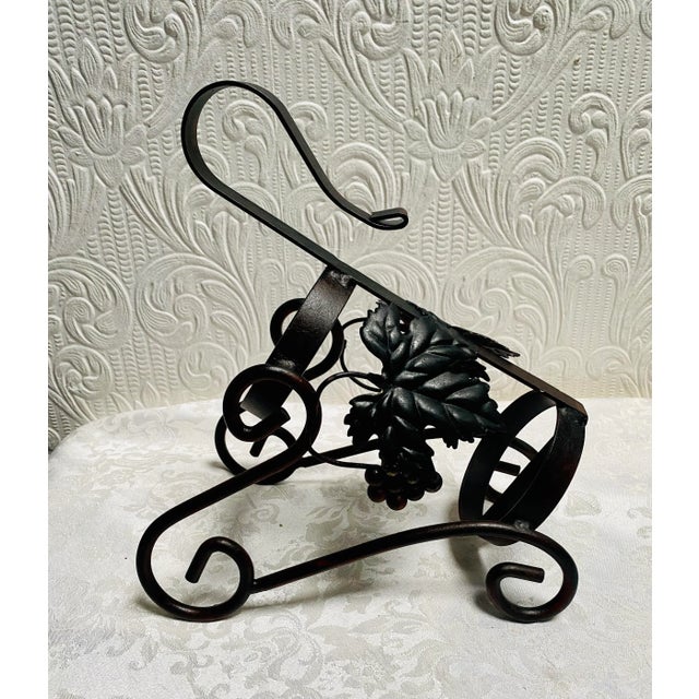 A beautiful Black vintage 1960’s iron grapes and leaves design wine bottle holder. The wine bottle is not included, only...