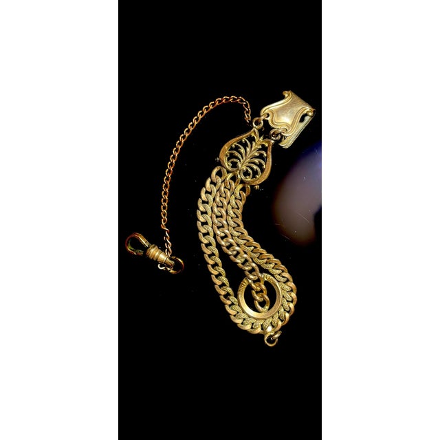 This pocket watch fob chain dates to the late Victorian era, dated sept 22, 1908 when such accessories were essential...