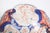 This porcelain plate displays a refined and elaborate design, characteristic of the Imari style, a type of Japanese...