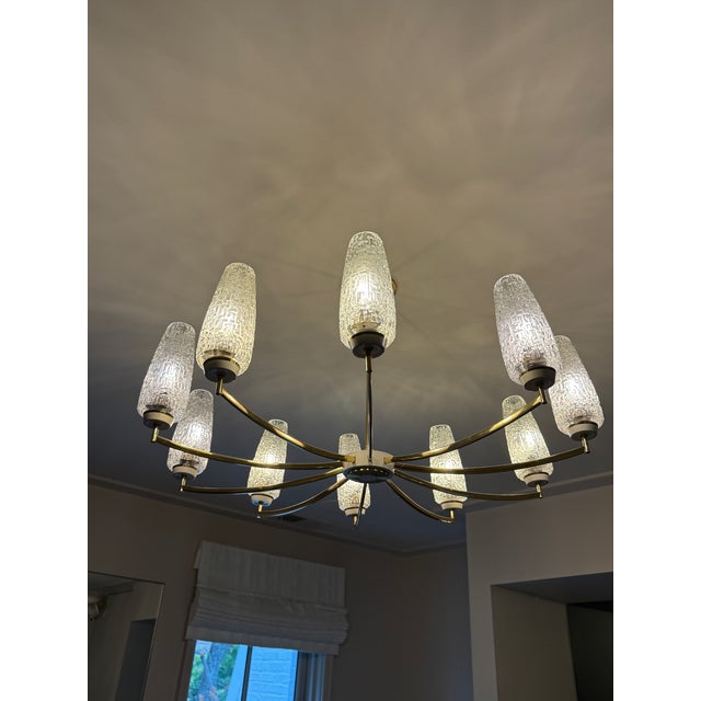 Vintage 10 Light Chandelier by Kaiser Leuchten Textured shades adorn a thin armed brass chandelier. This light (and many...