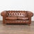 The soft patina of the brown vintage leather captures your attention in this wonderful Chesterfield loveseat or two seat...