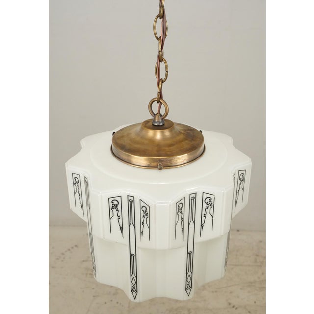 Art Deco pendant light with a white opal glass scalloped shade finished with geometric black stencil. The stencil has worn...