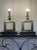 This pair of table lamps have a striking geometric design. The body consists of a square brass frame with an open center,...