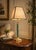 Architectural table lamp dating to the 1980s. A slender green column with a banded, swirling malachite-style finish rises...