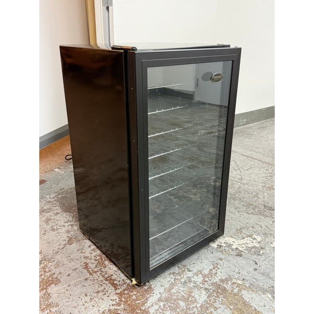 Design Plus Gallery presents a Vinotemp Wine Cooler. This compact cooler has a black cabinet, smoked glass door, chrome...