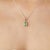 Crafted in 925 sterling silver, this emerald and diamond pendant features a beautifully cut emerald gemstone (5 x 7 mm,...