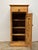 There is a quiet usefulness to a slim cupboard — a piece designed to fit where space is limited, yet still carry the full...