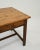 A wooden side table created in 1900s France. Simple, unassuming, and possessing a quiet disposition, the elegantly minimal...