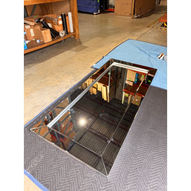 This contemporary rectangular mirror features a sleek beveled frame that creates clean lines and striking dimension. The...