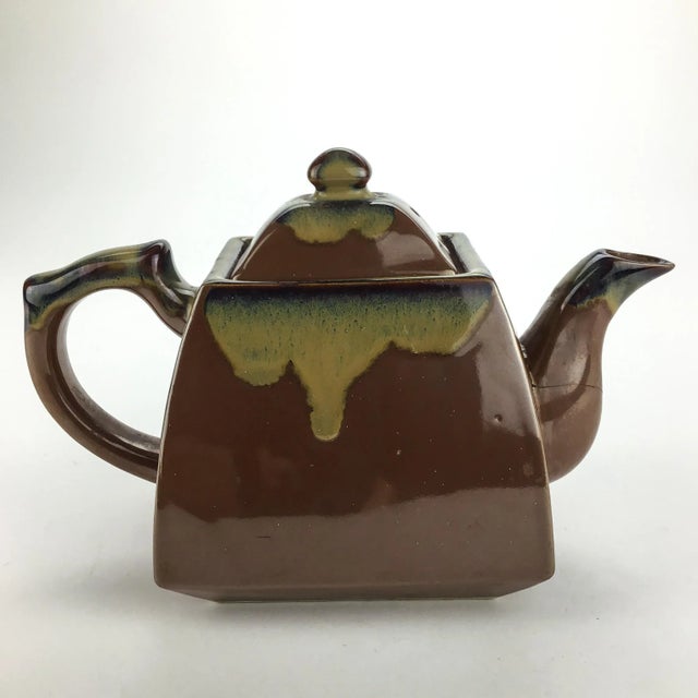 Nice size and glaze. Hand thrown with perfect fitting lid. All intact and works nicely for loose tea with holes inside to...