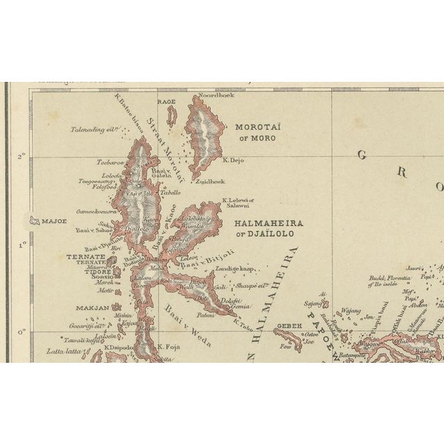 This decorative antique map depicts the Moluccan Islands (Spice Islands) and the western portion of New Guinea, focusing...