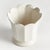 In a classic silhouette with petal edges, this footed pot is natureinspired. Finished in a softWhite reactive glaze, it is...