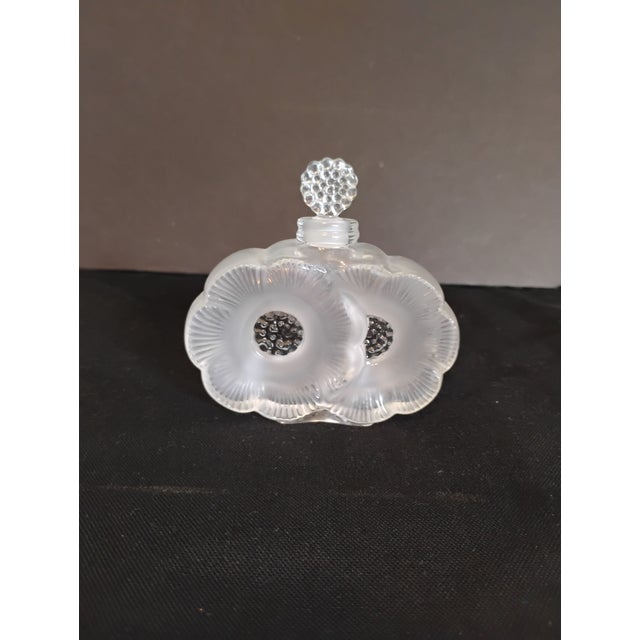 Lalique frosted crystal Duex Fluers perfume bottle. Beautiful piece measures 4" wide, 1" in depth and 3.75" in height,...