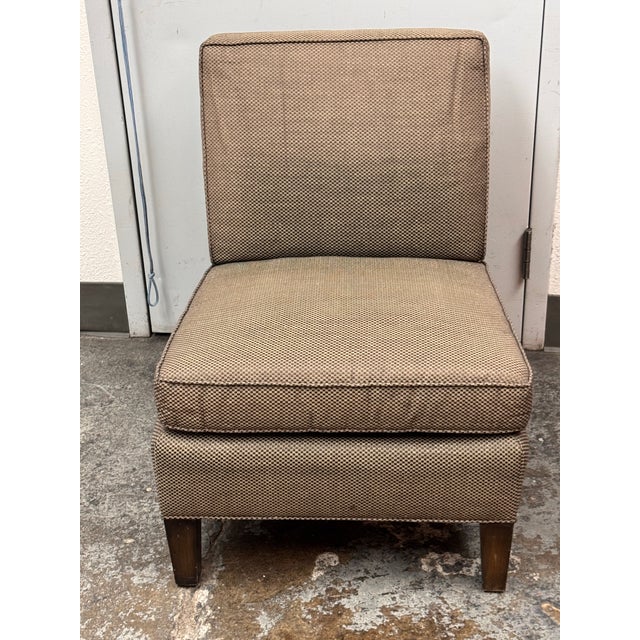 Design Plus Gallery presents a Henry Calvin Slipper Chair. This chair has a squared back, loose seat cushion, welted...