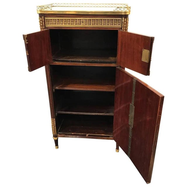 This refined Louis XVI style cabinet was crafted in France around 1880 and showcases the timeless elegance of 18th-...