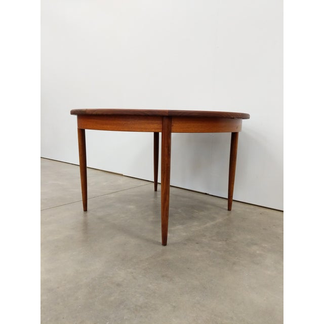 Authentic vintage mid century modern teak extendable dining table with built-in leaf. By G Plan (unmarked). This piece is...