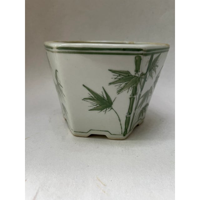Single hexagonal shaped footed ceramic cachepot or planter with chinoiserie bamboo decoration.