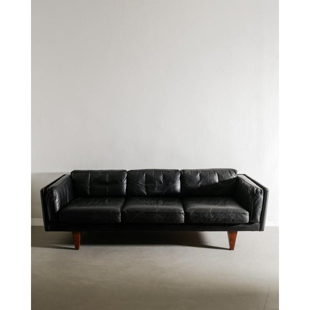 Rare danish mid century three seater sofa model "v11" in original black leather with matching sculptural rosewood feet by...