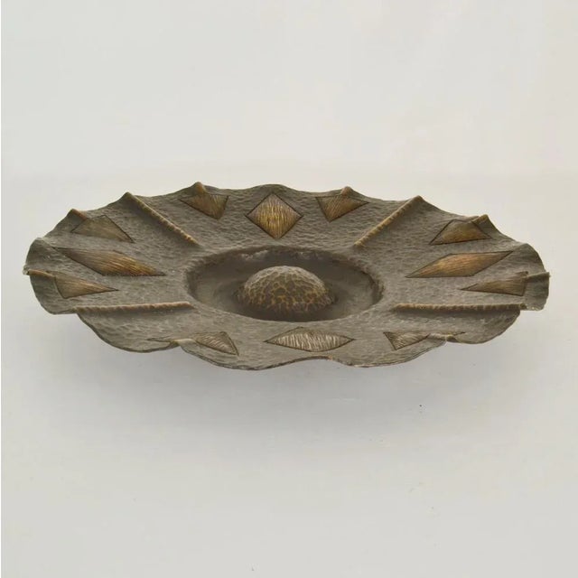 Brass bowl 1950s with flower shape relief and dark patina. Modernist hand-hammered bowl, decorative as a center piece and...