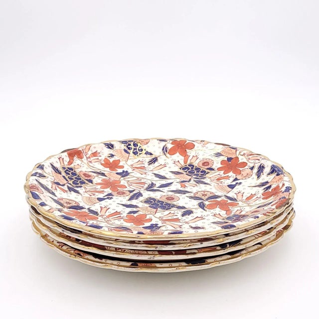 A set of four richly decorated plates in rust, cobalt blue, and gold, made in Staffordshire region of England circa 1880.