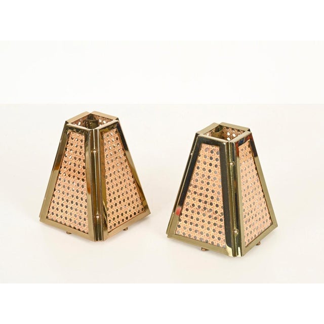 Fantastic pair of table lamps in gilt metal, vienna straw, and glass. These unique lamps were designed and produced in...