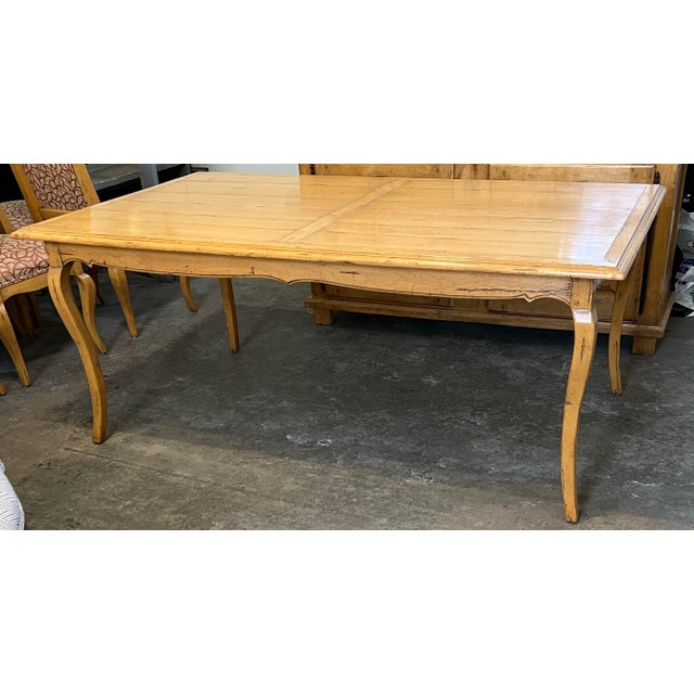 Exceptional solid-wood dining table by Guy Chaddock, featuring a wide plank top with breadboard ends and a hand-distressed...