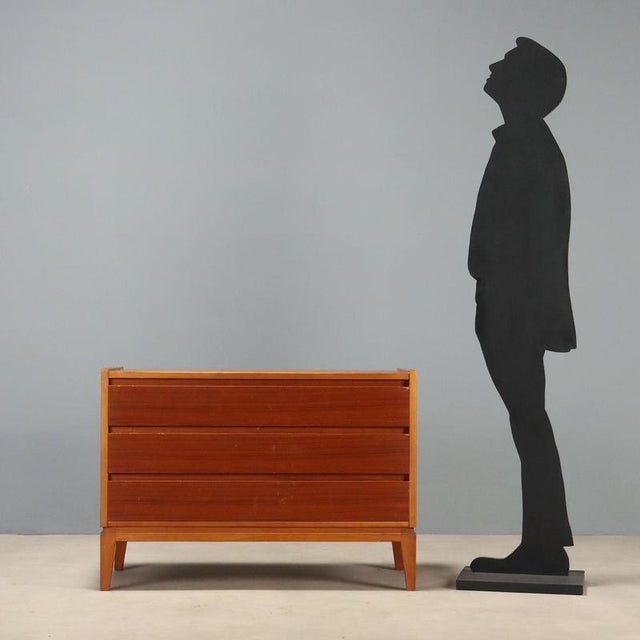 Vintage 1960s chest of drawers crafted from teak wood, featuring the simple and functional lines typical of the design...