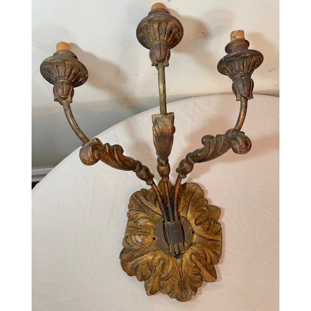 This antique wall sconce is a beautiful and intricately designed piece that will add a touch of elegance to any indoor...
