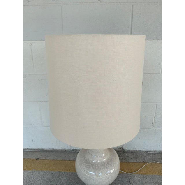 Stylish Arteriors Sutton Ivory Crackle Porcelain Lamp. Sculptural body with a linen cylinder shade. Original retail $687....