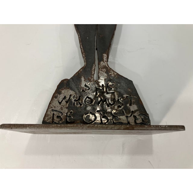 This solid steel sculpture is entitled “ She Who Must Be Obeyed “ C 99 could be the date Can not figure out the signature I