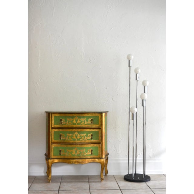 Striking painted green and gilt decorated commode or dresser, Italy, circa 1950s. This exquisite chest is designed with...