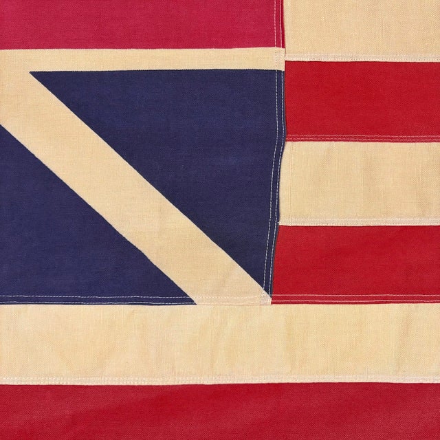This vintage American Grand Union flag is made from a cotton cloth with sewn stripes and printed emblem. Please note...