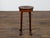 An English walnut stool from the 19th century with oval seat and central hand-cut handle. This charming 19th-century...