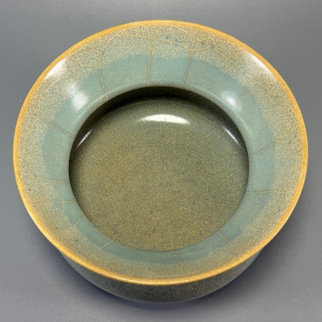 Classic Chinese official‑style celadon porcelain zhadou vessel, with flared wide rim, rounded bulbous body and short foot...
