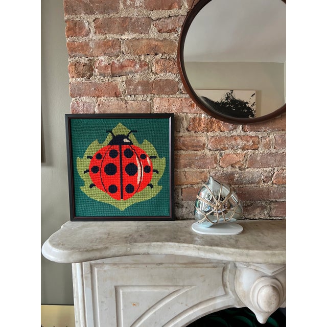 Vintage mid century wall art needlepoint of a lady bug framed.