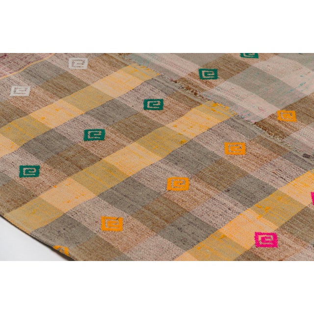 This is a vintage Turkish Oushak rug from the Mid 20th Century. The piece was hand-knotted.