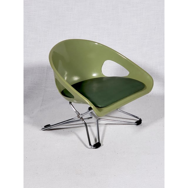 This item is an iconic Mid-Century Modern child's chair that can also be a booster chair. A futuristic design in the style...
