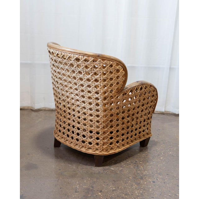 A rattan and French cane club chair in the Art Deco Revival style, produced circa 1980 with a construction quality —...