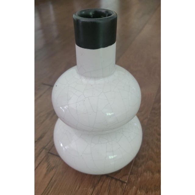 This striking vase has a contrasting black neck and crackle finish on its classic Chinese double gourd body. 7 1/2" tall,...