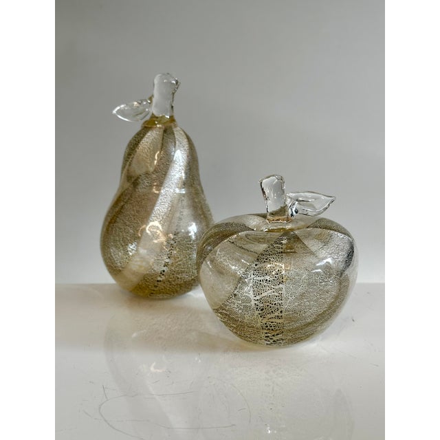 Exquisite two-piece set of decorative glass sculptures in the shape of an apple and a pear, meticulously handcrafted by...