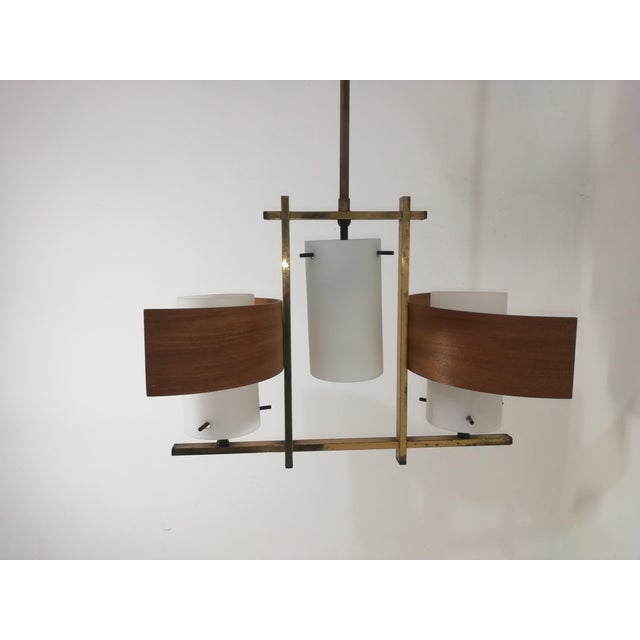 Three-light ceiling chandelier in opaline white glass, wood and brass. Original vintage. Can be mounted at two different...