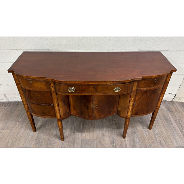 This is an absolutely stunning antique Federal style Hepplewhite or Sheraton style satinwood inlaid bow front sideboard,...