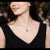 Elegant 14K white gold necklace featuring a natural oval-shaped emerald accented with 12 brilliant round diamonds. Estate...
